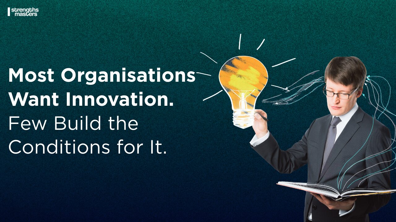 Business professional holding an open book with a glowing lightbulb illustration above it, alongside text reading “Most Organisations Want Innovation. Few Build the Conditions for It.” and Strengths Masters logo.