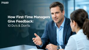 Manager giving structured feedback to employee in office, with “How First-Time Managers Give Feedback: 10 Do’s & Don’ts” text overlay on banner
